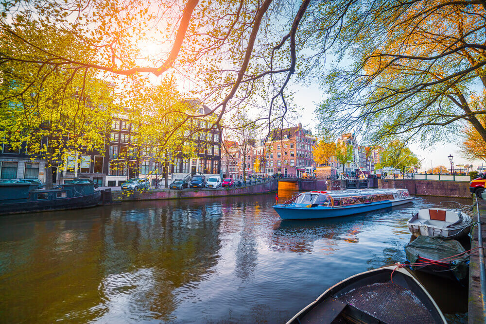 what makes an amsterdam canal tour in a small tourist boat so unique